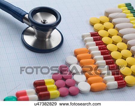 Stock Photo - Variety of medicine and stethoscope on graph paper to illustrate increase in medical drug use. Fotosearch