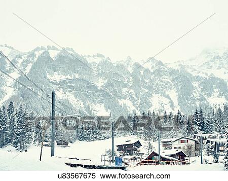View of traditional wooden cabins in snow covered valley, Wengen, Switzerland View Large Photo Image Stock Photography - View of traditional wooden cabins in snow covered valley, Wengen, Switzerland. Fotosearch