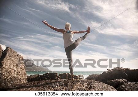 Woman practising yoga by ocean, Cape Town, South Africa View Large Photo Image Picture - Woman practising yoga by ocean, Cape Town, South Africa. Fotosearch