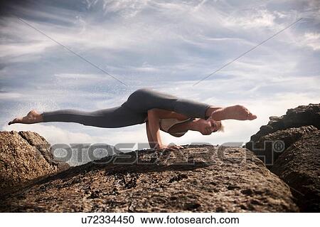 Woman practising yoga by ocean, Cape Town, South Africa View Large Photo Image Stock Image - Woman practising yoga by ocean, Cape Town, South Africa. Fotosearch