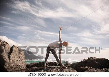Woman practising yoga by ocean, Cape Town, South Africa View Large Photo Image Stock Image - Woman practising yoga by ocean, Cape Town, South Africa. Fotosearch