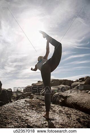 Woman practising yoga by ocean, Cape Town, South Africa View Large Photo Image Stock Photo - Woman practising yoga by ocean, Cape Town, South Africa. Fotosearch