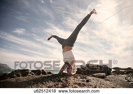 Woman practising yoga by ocean, Cape Town, South Africa View Large Photo Image Stock Photo - Woman practising yoga by ocean, Cape Town, South Africa. Fotosearch
