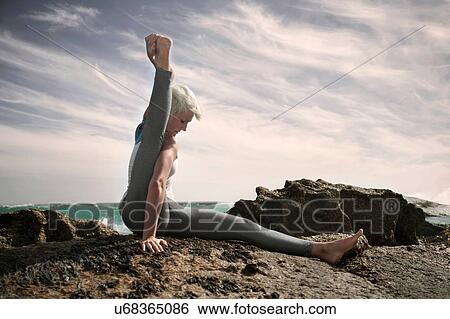 Woman practising yoga by ocean, Cape Town, South Africa View Large Photo Image Stock Photograph - Woman practising yoga by ocean, Cape Town, South Africa. Fotosearch