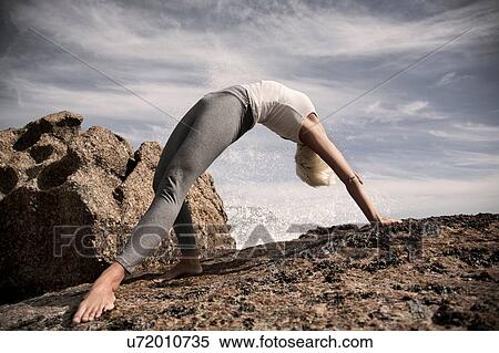 Woman practising yoga by ocean, Cape Town, South Africa View Large Photo Image Stock Photography - Woman practising yoga by ocean, Cape Town, South Africa. Fotosearch