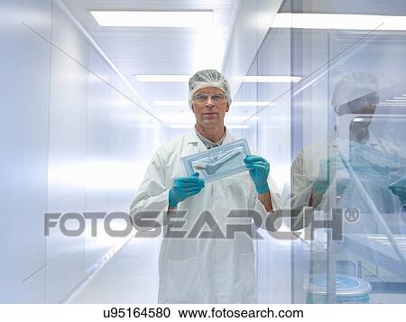 Worker holding orthopaedic hip stem replacement in clean room, portrait View Large Photo Image Stock Image - Worker holding orthopaedic hip stem replacement in clean room, portrait. Fotosearch