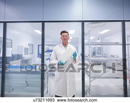 Worker holding orthopaedic medical product box outside clean room View Large Photo Image Stock Image - Worker holding orthopaedic medical product box outside clean room. Fotosearch