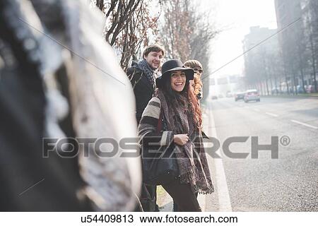 Young adults friends waiting to cross city road View Large Photo Image Stock Image - Young adults friends waiting to cross city road. Fotosearch