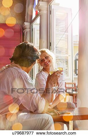 Stock Photo - Young couple drinking wine in restaurant, Havana, Cuba. Fotosearch