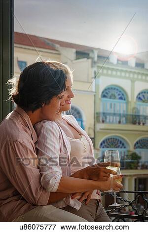 Young couple drinking wine on restaurant balcony in Plaza Vieja, Havana, Cuba View Large Photo Image Stock Photo - Young couple drinking wine on restaurant balcony in Plaza Vieja, Havana, Cuba. Fotosearch