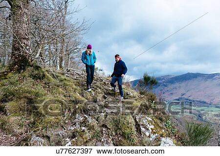 Young couple hiking, Derwent Water, Keswick, Lake District, Cumbria, United Kingdom View Large Photo Image Stock Photo - Young couple hiking, Derwent Water, Keswick, Lake District, Cumbria, United Kingdom. Fotosearch
