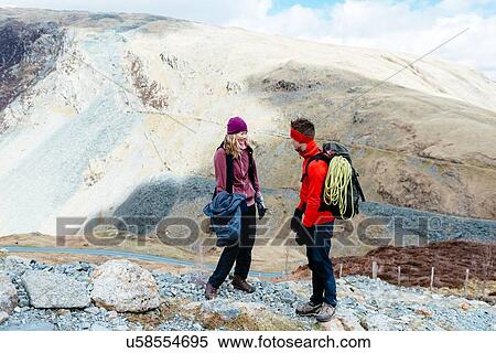 Stock Photography - Young couple hiking, Honister Slate Mine, Keswick, Lake District, Cumbria, United Kingdom. Fotosearch