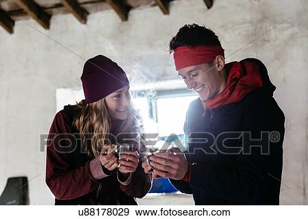 Stock Photo - Young couple hiking, in shelter for rest, Honister Slate Mine, Keswick, Lake District, Cumbria, United Kingdom. Fotosearch
