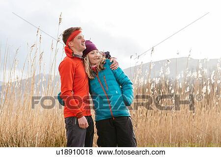 Young couple hiking, looking at view, Derwent Water, Keswick, Lake District, Cumbria, United Kingdom View Large Photo Image Stock Photo - Young couple hiking, looking at view, Derwent Water, Keswick, Lake District, Cumbria, United Kingdom. Fotosearch