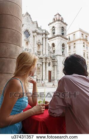 Young couple with Mojito cocktails in a restaurant on the Plaza de la Cathedral of Havana, Cuba View Large Photo Image Stock Photo - Young couple with Mojito cocktails in a restaurant on the Plaza de la Cathedral of Havana, Cuba. Fotosearch