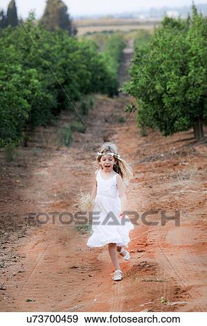 Young girl running in orchard, Israel View Large Photo Image Stock Photo - Young girl running in orchard, Israel. Fotosearch