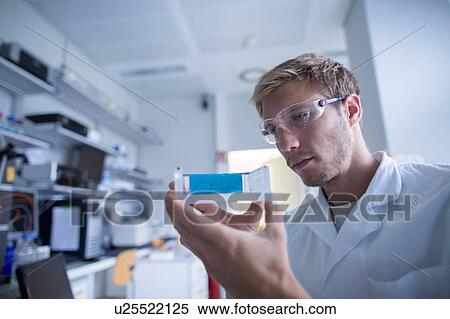 Young male scientist preparing experiment in lab View Large Photo Image Stock Photography - Young male scientist preparing experiment in lab. Fotosearch
