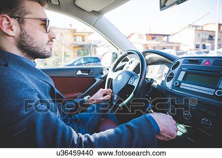 Young man driving car View Large Photo Image Stock Image - Young man driving car. Fotosearch