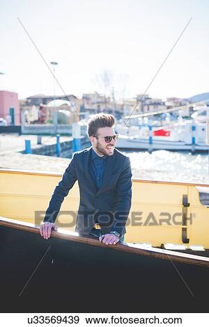 Young man looking out from lake ferry, Rovato, Brescia, Italy View Large Photo Image Stock Photo - Young man looking out from lake ferry, Rovato, Brescia, Italy. Fotosearch