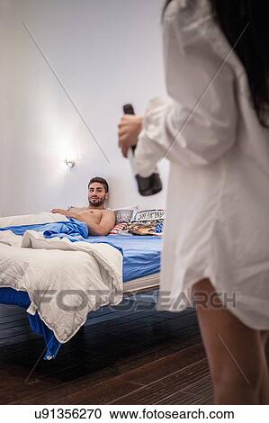 Young man lying in bed waiting for girlfriend View Large Photo Image Stock Image - Young man lying in bed waiting for girlfriend. Fotosearch