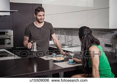 Young man pouring breakfast coffee for girlfriend View Large Photo Image Stock Photograph - Young man pouring breakfast coffee for girlfriend. Fotosearch