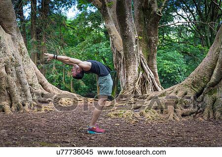 Young man practicing yoga in park, Sao Paulo, Brazil View Large Photo Image Stock Photography - Young man practicing yoga in park, Sao Paulo, Brazil. Fotosearch