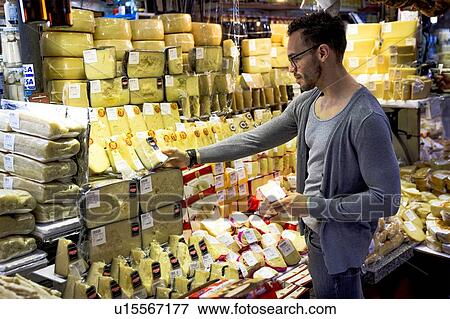 Young man selecting cheese in delicatessen market stall, Sao Paulo, Brazil View Large Photo Image Stock Photo - Young man selecting cheese in delicatessen market stall, Sao Paulo, Brazil. Fotosearch