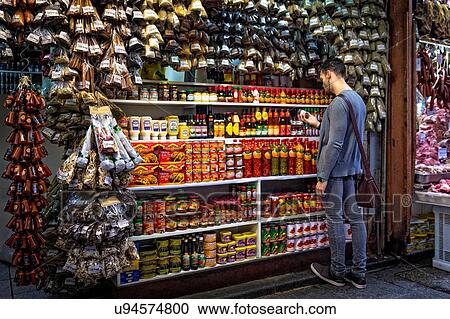 Young man selecting spices in market stall, Sao Paulo, Brazil View Large Photo Image Stock Image - Young man selecting spices in market stall, Sao Paulo, Brazil. Fotosearch