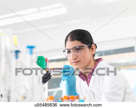 Young woman scientist viewing blood tube during clinical testing of medical samples in a laboratory View Large Photo Image Stock Photograph - Young woman scientist viewing blood tube during clinical testing of medical samples in a laboratory. Fotosearch