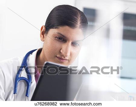 Doctor using a digital tablet View Large Photo Image Stock Image - Doctor using a digital tablet. Fotosearch
