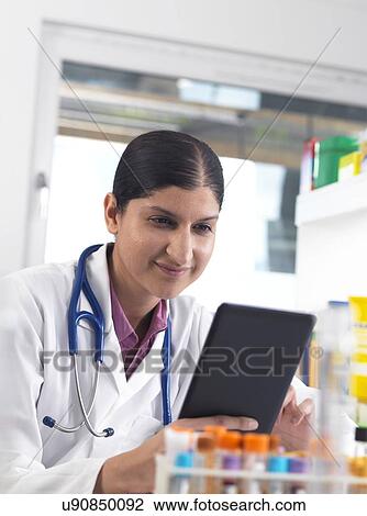 Doctor using a digital tablet View Large Photo Image Stock Image - Doctor using a digital tablet. Fotosearch