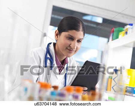 Doctor using a digital tablet View Large Photo Image Stock Photo - Doctor using a digital tablet. Fotosearch