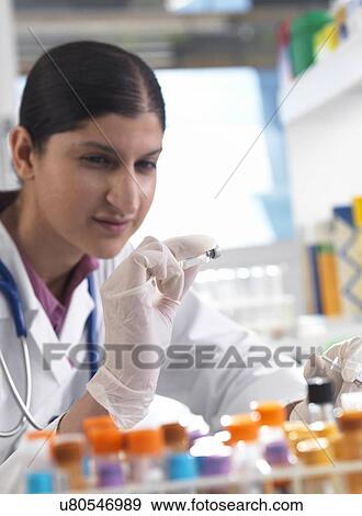 Stock Photo - Doctor with a drug vial. Fotosearch