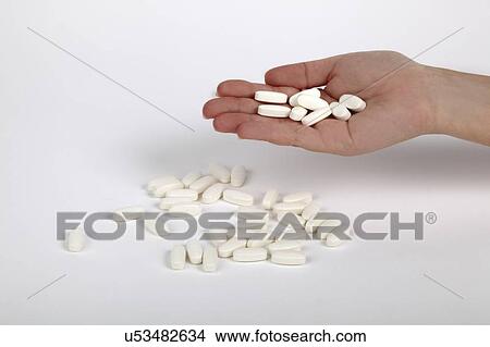 Picture - Hand selects a pill. Fotosearch