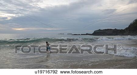 Boy running in waves on beach, Zihuatanejo, Guerrero, Mexico View Large Photo Image Stock Image - Boy running in waves on beach, Zihuatanejo, Guerrero, Mexico. Fotosearch