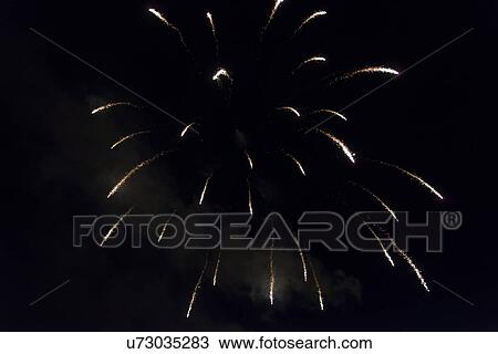 Stock Image - Fireworks display at night on Canada Day, Kenora, Lake Of The Woods, Ontario, Canada. Fotosearch