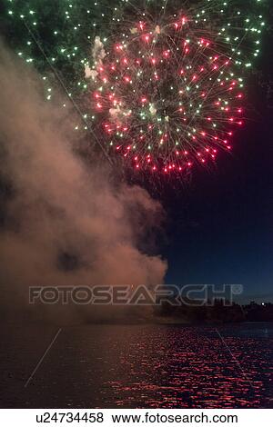 Stock Photo - Fireworks display at night on Canada Day, Kenora, Lake Of The Woods, Ontario, Canada. Fotosearch