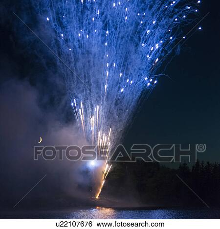 Stock Photograph - Fireworks display at night on Canada Day, Kenora, Lake Of The Woods, Ontario, Canada. Fotosearch
