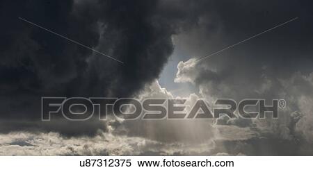 Stock Photography - Low angle view of dark storm clouds in the sky, Lake Of The Woods, Ontario, Canada. Fotosearch