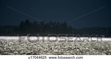 Stock Photography - Moonlight reflecting off the lake, Lake Of The Woods, Ontario, Canada. Fotosearch