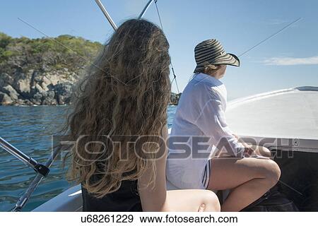 Stock Photo - Mother and daughter enjoying boat ride, Ixtapa, Guerrero, Mexico. Fotosearch