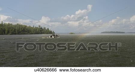Stock Photograph - Motorboat in a lake, Lake of the Woods, Ontario, Canada. Fotosearch