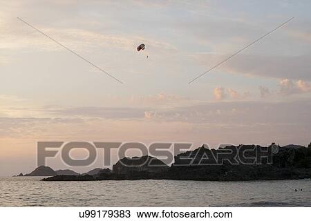 Parasailing at sunset, Zihuatanejo, Guerrero, Mexico View Large Photo Image Stock Image - Parasailing at sunset, Zihuatanejo, Guerrero, Mexico. Fotosearch