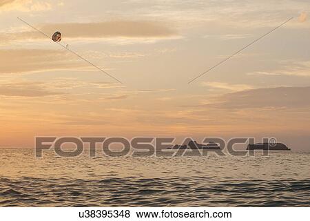 Stock Photo - Parasailing at sunset, Zihuatanejo, Guerrero, Mexico. Fotosearch