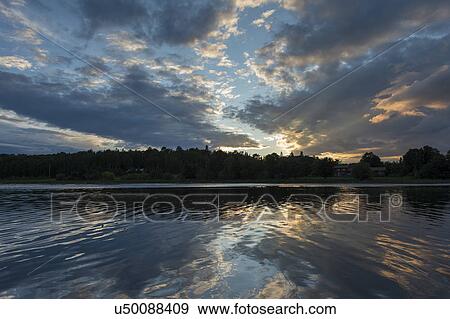 Stock Photo - Reflection of clouds in a lake, Lake of the Woods, Ontario, Canada. Fotosearch