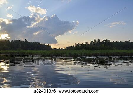 Stock Photograph - Reflection of clouds on water, Lake of the Woods, Ontario, Canada. Fotosearch