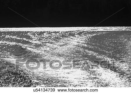 Stock Photo - Reflection of light off a lake, Lake Of The Woods, Ontario, Canada. Fotosearch