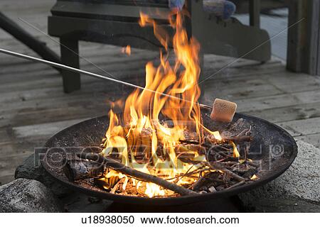 Roasting a Marshmallow over a Campfire, Lake Of The Woods, Ontario, Canada View Large Photo Image Stock Image - Roasting a Marshmallow over a Campfire, Lake Of The Woods, Ontario, Canada. Fotosearch