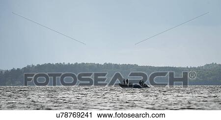 Silhouette of people on boat in a lake, Lake of the Woods, Ontario, Canada View Large Photo Image Stock Image - Silhouette of people on boat in a lake, Lake of the Woods, Ontario, Canada. Fotosearch
