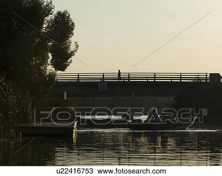 Stock Image - Tourists on boats in a lake, Kenora, Lake Of The Woods, Ontario, Canada. Fotosearch
